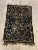A Hand knotted Persian rug, the field with geometric design enclosed by a border with guard stripes,