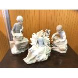 A group of three Nao figures including girl on suitcase with duck in basket measures 27cm high, girl