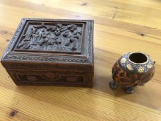 A carved Chinese box, the hinged lid with figures in relief, measures 11cm x 20cm x 15cm along