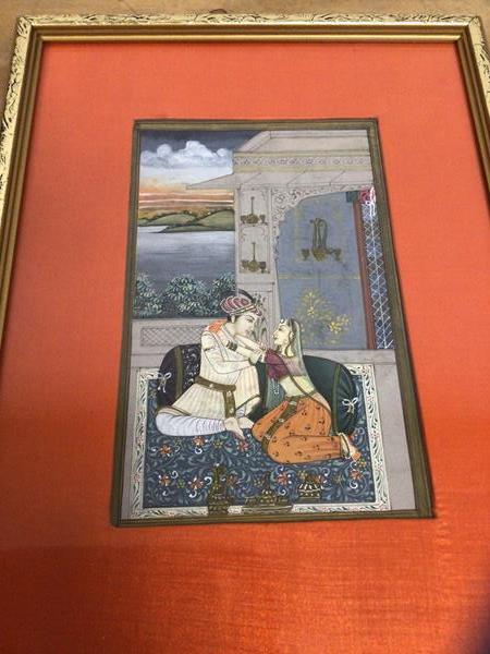 A modern Indian miniature painting in the Mughul style of a couple on rug, paper label verso