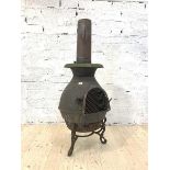 A Cast metal chimenea on a scrolled tripod base, H123cm