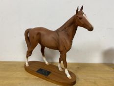 A Beswick figure of a horse on wooden base bearing label The Minstral Racehorse of the Year 1977