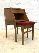 A mid 20th century teak Chippy telephone table, with slide, drawer, open shelf and slide out