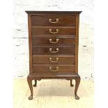 An Edwardian mahogany sheet music cabinet, with six fall front drawers, raised on cabriole supports,