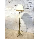 An Edwardian telescopic brass standard lamp with scrolled decoration and square tapered shade,