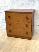 A mid century teak veneered chest, fitted with three drawers, H74cm, W70cm, D45cm