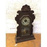 A 1920's mantel clock in moulded case, dial inscribed The Ansonia Clock Company Manufacturers USA,