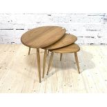 An Ercol blonde elm 'Pebble' nest of three tables, each raised on turned supports, H40cm, W65cm,