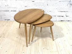 An Ercol blonde elm 'Pebble' nest of three tables, each raised on turned supports, H40cm, W65cm,