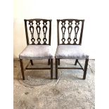 A Pair of Georgian style mahogany dining chairs, with shaped crest rail over pierced splat back,