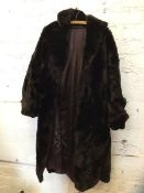 A fur ? coat with single pocket to exterior, measures 34cm across the shoulders x 110cm