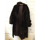 A fur ? coat with single pocket to exterior, measures 34cm across the shoulders x 110cm