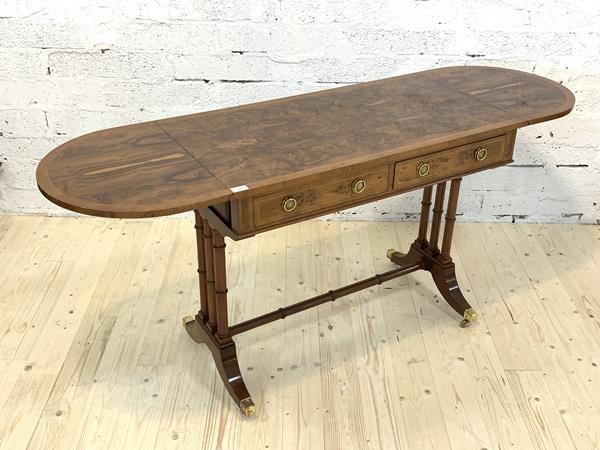A Quality reproduction figured walnut and yew wood sofa table of Regency design, the cross banded