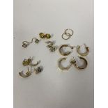 A collection of 9ct gold and yellow metal earrings some with stones some marked (a lot)