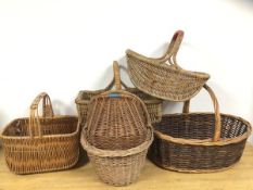 A group of six wicker baskets, five with fixed handles, one with no handle. Largest measures 37cm
