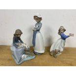 Three Nao figures of young girls with animals, tallest measures 26cm high (3)