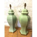 A near pair of faceted baluster shaped table lamps celandine green on metal bases with brass