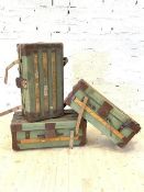 A Set of three early 20th century green canvas streamer trunks, pine and leather bound, the lid