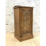 A Late Victorian figured walnut bedside cupboard, the raised back over panelled door enclosing a