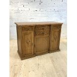 An early 20th century Continental inverted break centre bow front credenza, the marble top over four