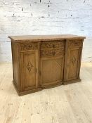 An early 20th century Continental inverted break centre bow front credenza, the marble top over four