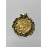 A 1994 1/10 oz Krugerrand in a 9ct gold mount with diamonds