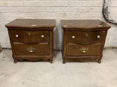 A Pair of continental oak serpentine bedside tables, each fitted with two drawers, raised on