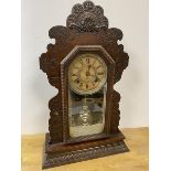 A 1920's mantel clock with moulded frame measures 58cm high