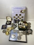 A quantity of commemorative coins including Euros, Crowns, half Dollar, two commemorative coins with