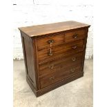 An Edwardian walnut chest, fitted with two short and three long graduated drawers, raised on a