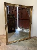 A large gilt framed wall hanging mirror, with bevelled glass, 105cm x 135cm