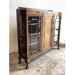 An Edwardian mahogany display cabinet, the raised back over two glazed doors, each enclosing three