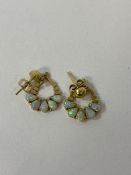 A pair of yellow metal opal set earrings measure 1cm across, 1 back marked 14 the other 18