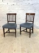 A Pair of late 19th century mahogany dining chairs with upholstered seats raised on square tapered