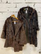 A fur coat with two exterior pockets measures 32cm across shoulders x 83cm and another fur coat