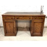 A Victorian mahogany twin pedestal desk, the top with inset skiver writing surface over three