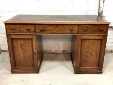 A Victorian mahogany twin pedestal desk, the top with inset skiver writing surface over three