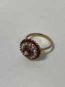 A pearl and ruby cluster ring with 9ct gold mount and shank size R/S