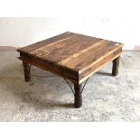 An eastern hardwood low table, studded and strap bound, raised on turned supports, H39cm, 81cm x