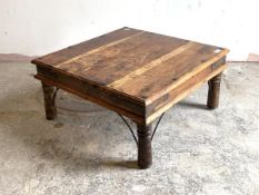 An eastern hardwood low table, studded and strap bound, raised on turned supports, H39cm, 81cm x