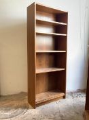 A mid century teak veneered floor standing bookcase, with four adjustable shelves, H194cm, W83cm,