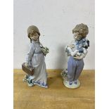 Two Lladro figures, one of boy holding puppy the other of girl with bouquet and travelling case,