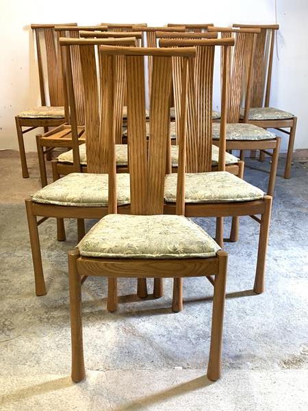 Ercol, a set of twelve blonde dining chairs, the turned crest rail over ribbed and serpentine