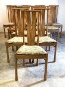 Ercol, a set of twelve blonde dining chairs, the turned crest rail over ribbed and serpentine