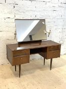 A Mid century walnut veneered dressing table, the mirror back with twin sconces over four drawers,