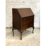 An Early 20th century figured mahogany bureau, the cross banded fall front revealing inset writing