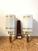 A mid century twin branch teak and brass wall sconce, circa 1950-1960, with cylindrical opaline
