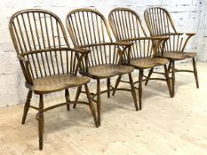 A Set of four elm and ash Windsor armchairs, the double hoop and spindle back over saddle seats,