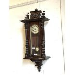 A late Victorian Vienna style wall clock, twin train spring driven movement striking on a coiled