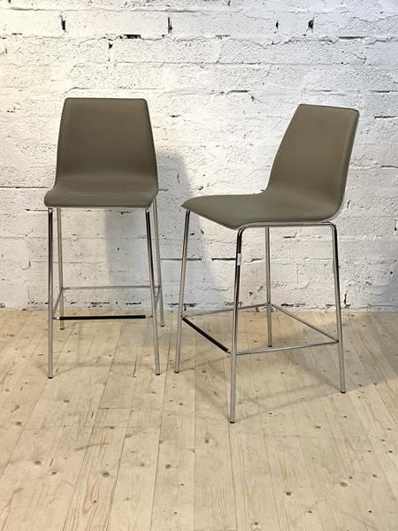 A Pair of Italian bar chairs, the seat and back upholstered in grey and white faux leather, raised